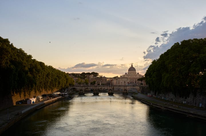 A photo of the Tiber river in Rome at sunset.